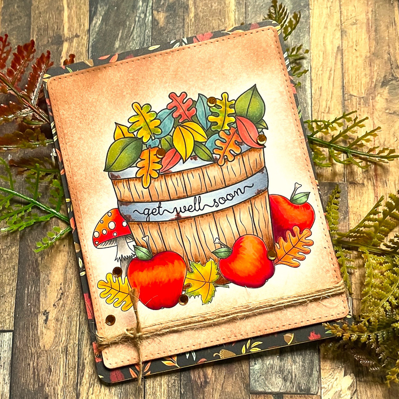 handmade get well soon card featuring autumn apples and leaves in a barrel against a wooden background with autumn foliage