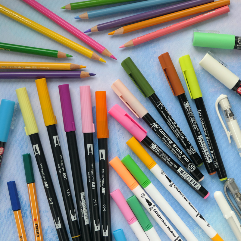 selection of colourful pens and pencils recommended for creative bullet journaling 