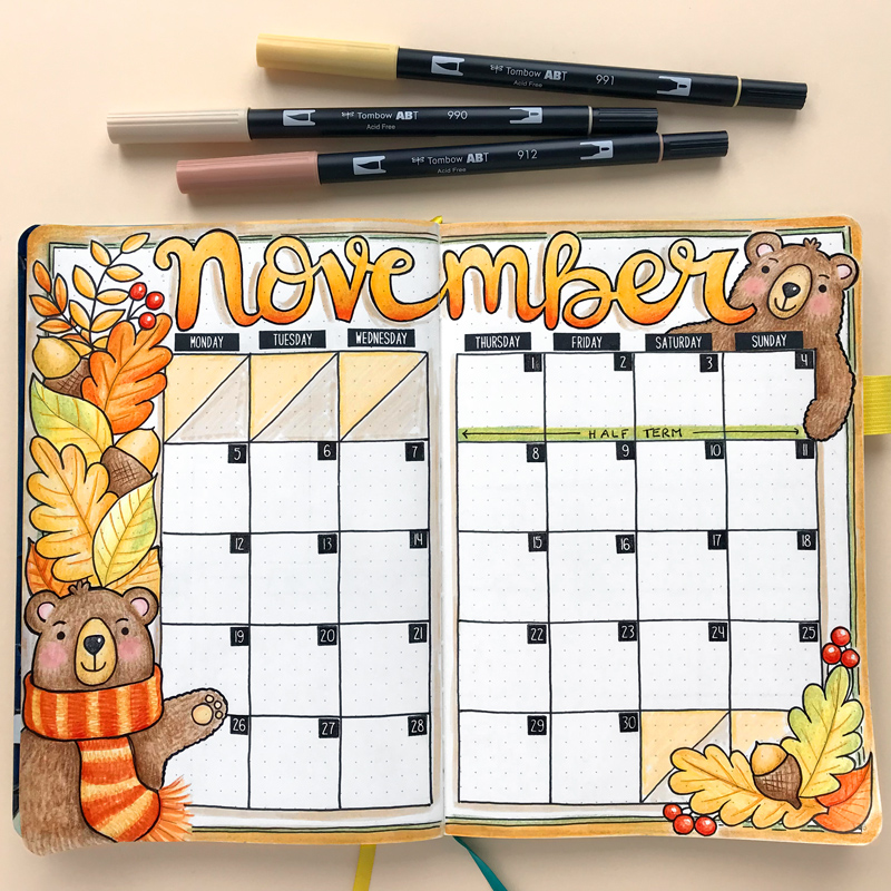 hand-drawn monthly bullet journal spread for November with autumn leaves and cosy bears