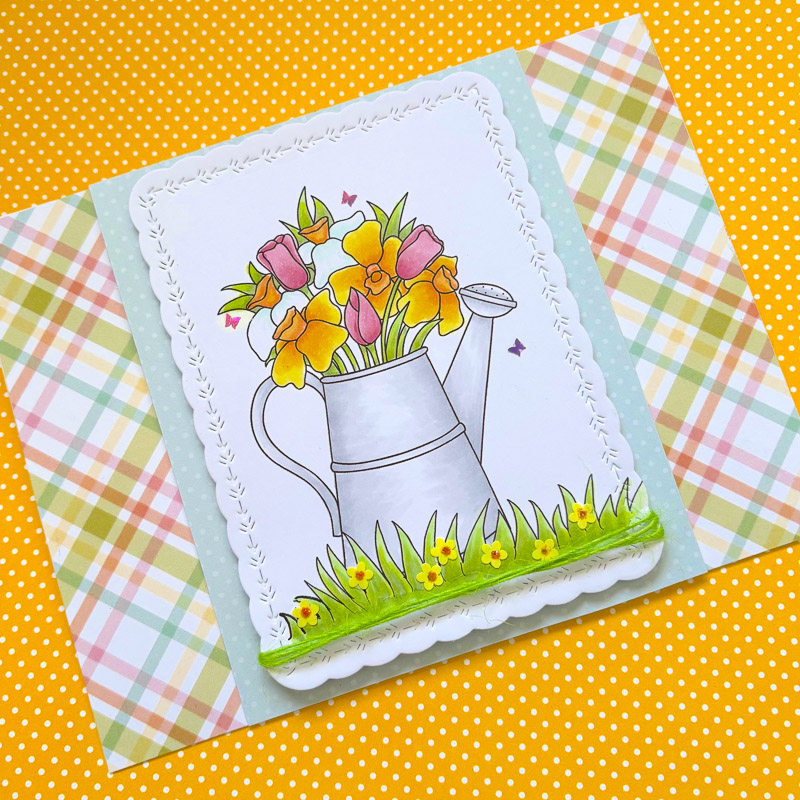 handmade floral greetings card with daffodils and tulips in a watering can with fresh spring colours