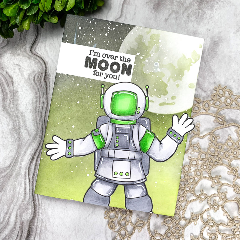 handmade space themed greetings card with colourful astronaut against a green galaxy background