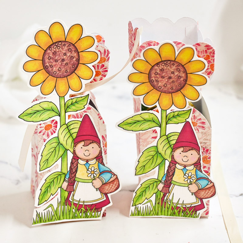 colourful gift boxes with a hand drawn sunflower and garden gnome on the front, tied with ribbon