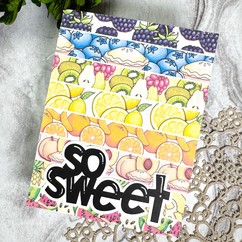 hand-made greetings card with strips of different fruit papers and a bold so sweet sentiment set on a marble table