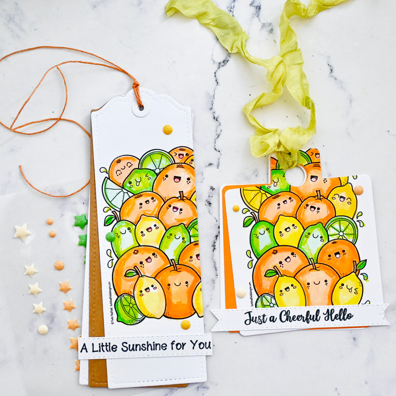 hand-made bookmark and gift ga set decorated with lots of happy, smiling kawaii style citrus fruit designs set on a marble table cloth